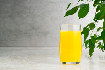 glass of tasty orange juice on table. glass of orange juice with copy space on grey background.