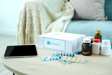 First aid kit box delivery service from hospital and table placed on table in front of blue fabric sofa.