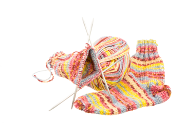Isolated handmade woolen socks with knitting equipment
