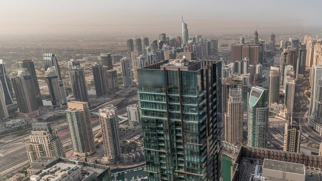 Panorama showing Dubai Marina and JLT with JBR district. Ttraffic on highway between skyscrapers aerial timelapse.