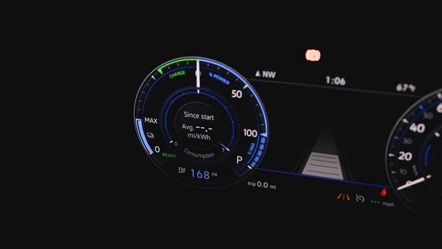 Electric car dashboard display closeup. Electric Car Concept. Battery indicator showing an increasing battery charge. The battery indicator shows it fills up to 168 mi. Electric Car Battery Gauge.