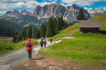 Fototapeta na wymiar Hiker group with backpacks on the hiking trail, Dolomites, Italy