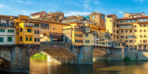 Fototapeta na wymiar Panorama of beautiful medieval bridge Ponte Vecchio over Arno River, Florence, Italy. Architecture and landmark of Florence. Travel concept background.