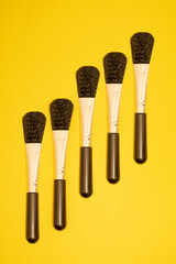 set of brushes, blushes on yellow background 