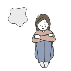 膝を抱えて泣いている女性