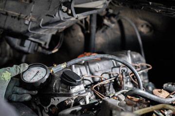 Fototapeta na wymiar measurement of compression pressure in the cylinders of a car engine.