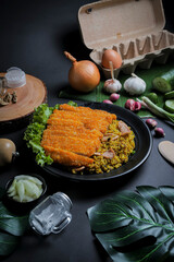 Fried Rice or Nasi Goreng from Indonesia with Crispy Chicken, Seasoning and Spices Isolated