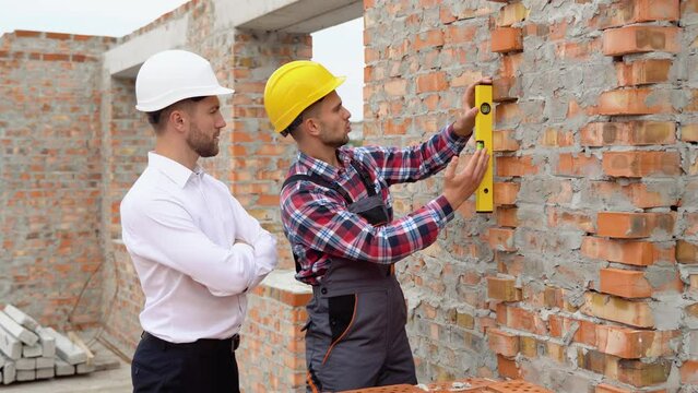 Two engineers working in a construction site, close up