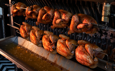 Roast chicken in the rotisserie machine, close up