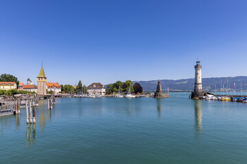 Obraz premium Marina of Lindau, Bodensee, Germany, with the lighthouse, the Bavarian Lion and the Mangturm tower in the background