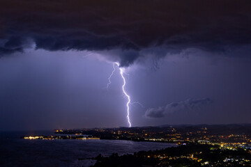 Massive lightning strike during thunderstorm over the Bodensee lake in Austria/Germany with the...