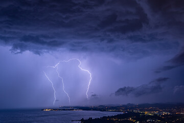 Triple lightning strike during thunderstorm over the Bodensee lake in Austria/Germany with the...