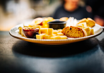 different types of cheese on a plate in cafe