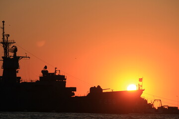 sunset over military ship