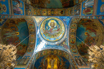 Fototapeta na wymiar St. Petersburg, Russia - June 26, 2022: Painting on the ceiling of the famous Church of the Savior on Spilled Blood. Fresco icon portrait of St. Jesus from inside the dome of the temple