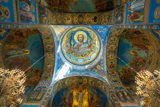 St. Petersburg, Russia - June 26, 2022: Painting on the ceiling of the famous Church of the Savior on Spilled Blood. Fresco icon portrait of St. Jesus from inside the dome of the temple