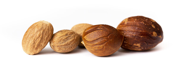 Nutmeg close-up on a white background. Indian spices close up. Medicinal herbs and spices.