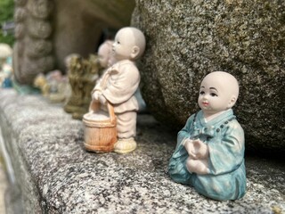 Closeup shot of baby monk statues