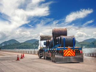 Coils of steel wire rod on truck trailer at port industrial zone. Truck receive steel wire rod from port to store at warehouse.