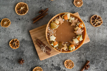 Sweet cheesecake with caramel on the table