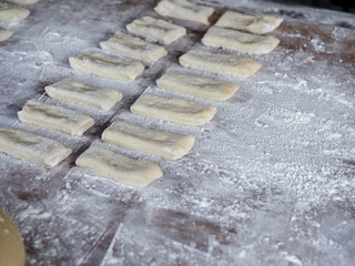 Preparation of raw materials for making deep-fried dough sticks or Patongko with wheat flour before throw in boiling oil to fry, Asian famous street food in Thailand, Chinese doughnuts style.