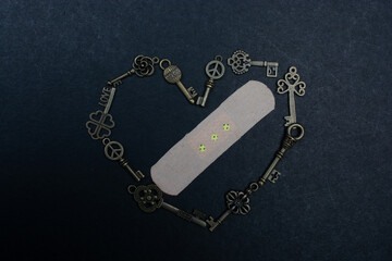 Fototapeta na wymiar Retro metal keys form a heart shape with plaster in