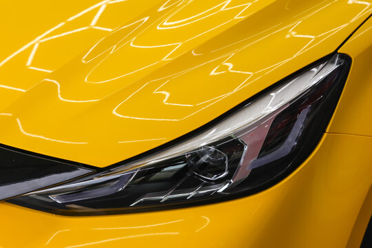 Close up side of headlight on a yellow car.Selective focus.