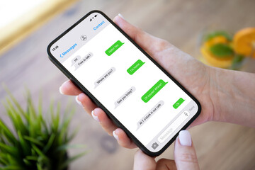 woman hands holding phone with app messenger on the screen