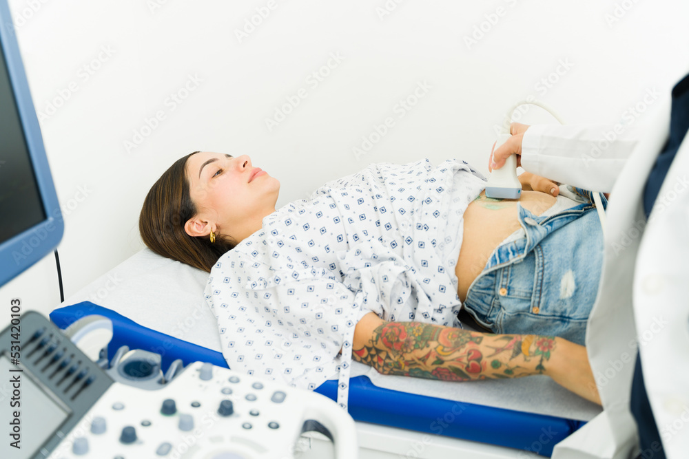 Wall mural Sick woman at the imaging lab getting a stomach sonography