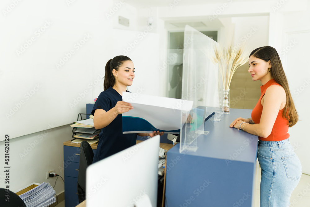 Wall mural Young woman receiving her ct scans or x-ray images at the lab