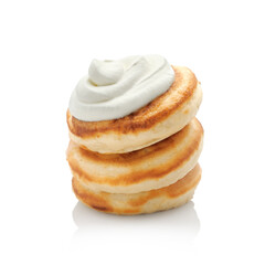 Stack of thick fluffy pancakes with sour cream isolated on white background    