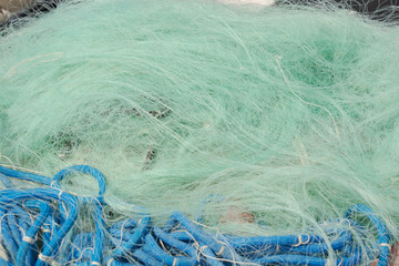 knotted fine mesh fishing nets in a pile after fishing in the adriatic sea