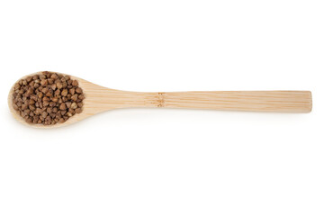 Buckwheat on an isolated white background. Buckwheat in a wooden spoon.