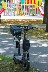 Naklejka premium A black scooter and a colorful playground for kids
