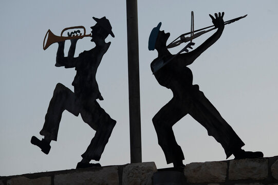 Silhouette Metal Cutouts Of Dancing Orthodox Jewish Men On A Rooftop In Northern Israel.