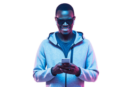 Portrait of young african american man using phone to listen music with earphones