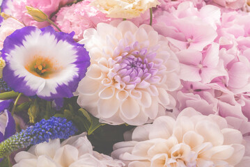 Pink and purple bouquet of flowers in a pink box isolated on white.