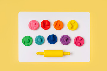 Colorful letters. Inscription Play dough in rainbow colored. Art Activity for Kids. Fine motor skills. Sensory play for toddlers.