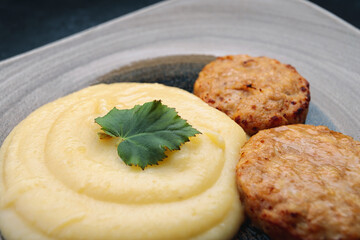 Mashed potatoes with steam cutlets and parsley