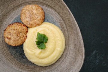 Mashed potatoes with steam cutlets and parsley