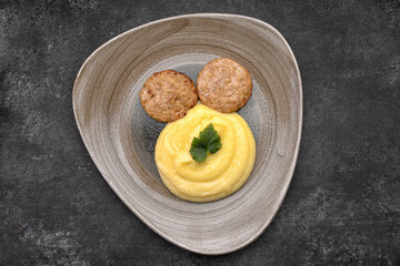 Mashed potatoes with steam cutlets and parsley