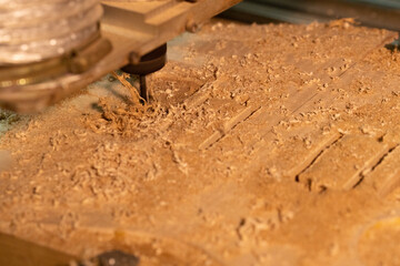 CNC machine is drilling hole on a body of electric guitar.