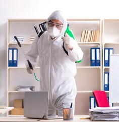Professional contractor doing pest control at office