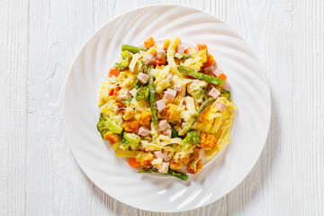 Ham and Noodle Casserole on white plate, top view