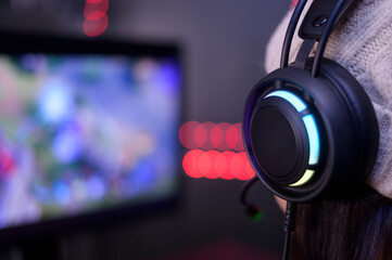 Fototapeta na wymiar Young female professional Streamer and gamer with headset playing online video games
