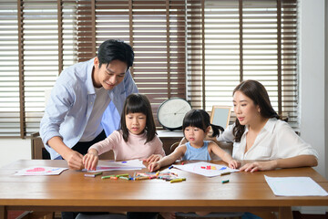 Asian family with children Drawing and painting on table in playing room at home, Educational game.