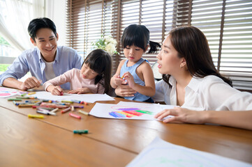 Asian family with children Drawing and painting on table in playing room at home, Educational game.