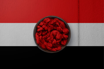 Wooden basket on background in colors of national flag. Photography and marketing digital backdrop. Yemen