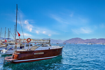 Naklejka na ściany i meble Landscape of private luxury boat moored in a blue azure lagoon
