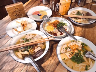 authentic Thai breakfast, glass noodles, steamed toast, milk tea and porridge 